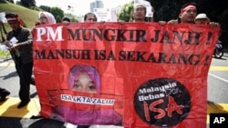 Malaysian activists hold a banner in a protest against the Internal Security Act (ISA) outside the parliament house in Kuala Lumpur, April 9, 2012