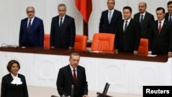 In this file photo, Turkey's new President Tayyip Erdogan (front C) attends a swearing in ceremony at the parliament in Ankara, August 28, 2014.
