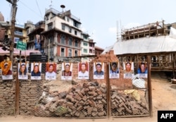 Portraits of victims are seen at the reconstruction site of Kathmandu's Durbar Square which was damaged by a 2015 earthquake, on the fourth anniversary of the disaster in Kathmandu, April 25, 2019.