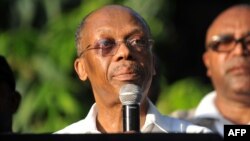 Former Haitian President Jean Bertrand Aristide speaks to supporters at the entrance to his home in Port-au-Prince, after giving a speech for the opening ceremony of the Lavalas Political Party, Sept. 30, 2015.
