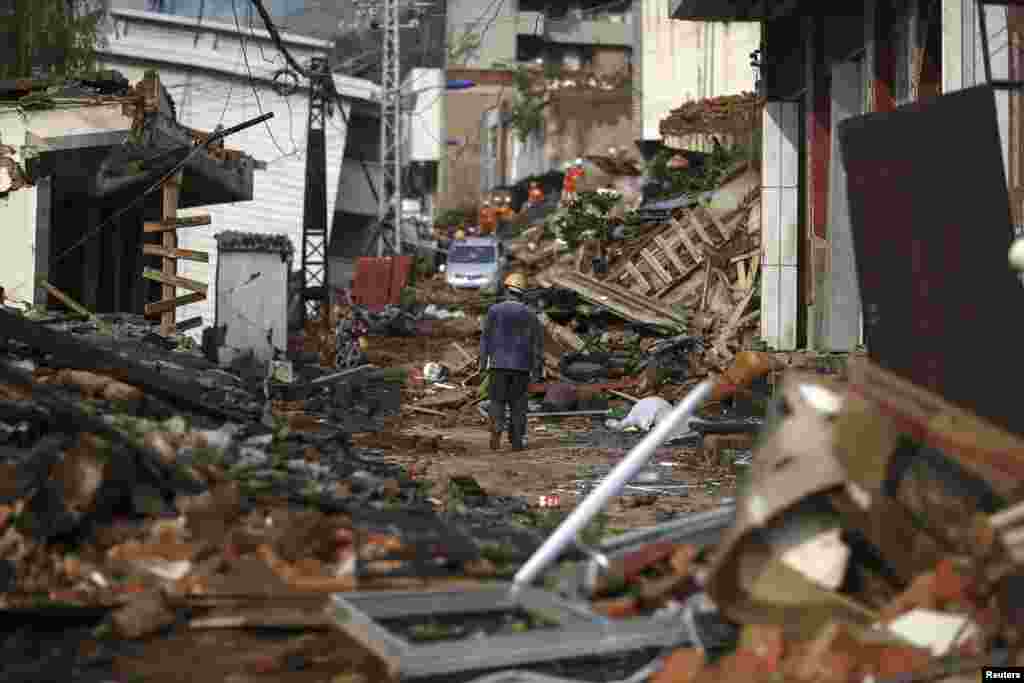 A man walks among the collapsed buildings after a&nbsp;magnitude 6.3 earthquake hit Longtoushan township, Ludian county, Yunnan province, Aug. 4, 2014.