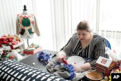 Doris Cochran works on "an ugly sweater," which she is planning to sell, Jan. 18, 2019 in her apartment in Arlington, Virginia.