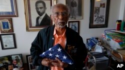 World War II veteran Johnnie Jones, Sr. poses for a portrait at his home in Baton Rouge, La., Tuesday, May 28, 2019. He remembers wading ashore and one incident when he and his fellow soldiers came under fire from a German sniper. (AP Photo/Gerald Herbert)