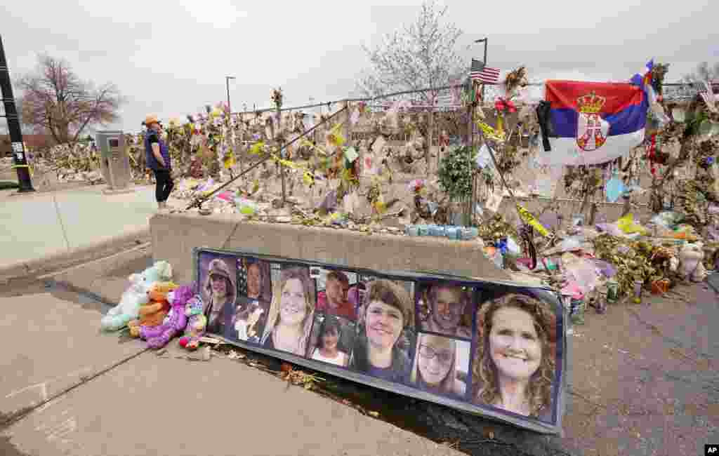 The photographs of the 10 victims of a mass shooting in a King Soopers grocery store adorn a cement barrier outside the store on Friday, April 23, 2021, in Boulder, Colo. The man accused of killing the people at the crowded Colorado supermarket last month