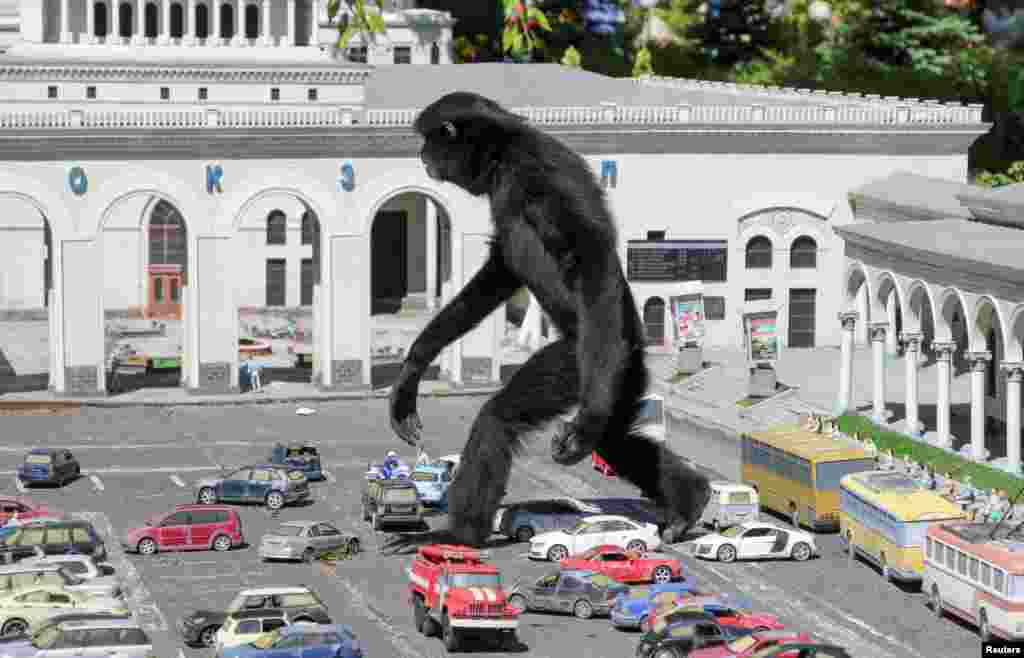 A gibbon walks amid models of vehicles at a zoo in the park of miniatures in Bakhchisaray, Crimea.