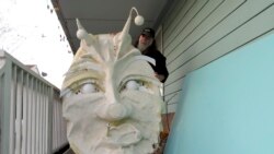 Thom Karamus shows his paper mache head from "Alice in Wonderland," made in New Orleans, on Wednesday, Jan. 14, 2021. (AP Photo/Janet McConnaughey)