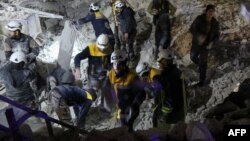 Syrian emergency personnel search for victims following an explosion at a base for Asian jihadists in a rebel-held area of the northwestern city of Idlib, Jan. 7, 2018. 