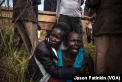 The sister of Duku Evans — who was killed November 3 amid fighting between government troops and rebels in Logo displaced persons camp in Kajo Keji, South Sudan — wails as the casket containing her brother's body is carried by at his funeral on the Ugandan border, Nov. 5, 2017.