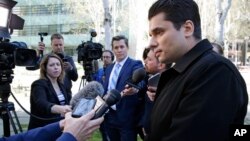 Igor Litvak (right) the attorney for Russian hacker Roman Seleznev, talks to reporters, April 21, 2017, in Seattle, following the federal court sentencing of Seleznev to 27 years in prison after he was convicted of hacking into U.S. businesses to steal credit card data.