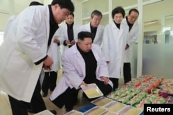 FILE - North Korean leader Kim Jong Un (C) provides field guidance at Kumkop General Foodstuff Factory for Sportspersons in this undated photo released by North Korea's Korean Central News Agency (KCNA) in Pyongyang, Jan. 8, 2015.