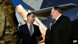 Secretary of State Mike Pompeo, center, talks with Charge D'affaires at the U.S. Embassy in Baghdad Joey Hood, in Baghdad, May 7, 2019. British Maj. Gen. Chris Ghika, a senior officer in the U.S.-led military coalition says there is no increased threat from Iran or Syria.