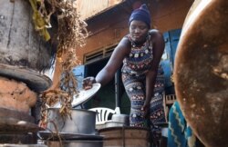 Fridah Namuganza, a Ugandan student, works as a waitress in the Kayunga district of Central Uganda, Jan. 7, 2022.