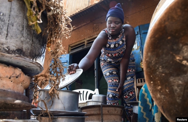 Fridah Namuganza, a Ugandan student, works as a waitress in the Kayunga district of Central Uganda, Jan. 7, 2022.
