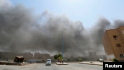 Smoke rises after what activists say was shelling from forces loyal to Syria's President Bashar al-Assad in Raqqa, Aug. 17, 2014. 
