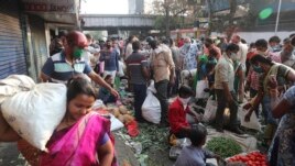 Indians crowd a vegetable market in Mumbai, India, Wednesday, March 25, 2020.