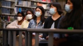 Senior Annie Chen, center, listens with classmates as Connecticut Attorney General William Tong speaks for Asian Pacific American Heritage Month at Farmington High School in Farmington, Conn on May 10, 2020. (AP Photos/Jessica Hill)