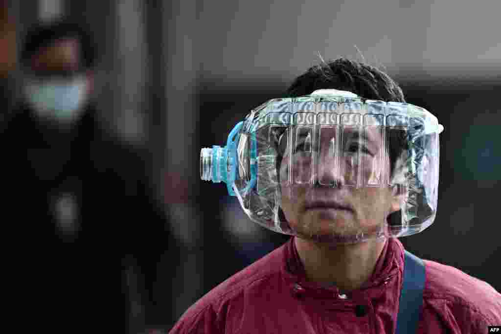 A person in Hong Kong wears a plastic water bottle to cover her face as a preventative measure following a virus outbreak that began in the Chinese city of Wuhan.