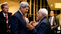 FILE - Secretary of State John Kerry talks with Iranian Foreign Minister Mohammad Javad Zarif in Vienna, after the International Atomic Energy Agency (IAEA) verified that Iran has met all conditions under the nuclear deal. 