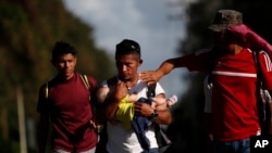 Hombres, mujeres y niños integran la nueva caravana de hondureños que ha atraviesa el territorio de Guatemala el 15 de enero de 2020.