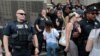 FILE - Family members of detainees line up to enter a federal court just before a hearing to consider a class-action lawsuit filed on behalf of Iraqi nationals facing deportation, in Detroit, Mich., June 21, 2017.