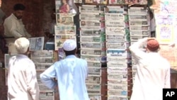 Pakistan citizens read posted newspapers, May 3, 2011