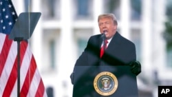 FILE - Then-President Donald Trump speaks during a rally protesting the electoral college certification of Joe Biden as president, in Washington, Jan. 6, 2021.