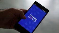 A man shows the contact tracing app Stayaway Covid on his cellphone, in Lisbon, Thursday, Sept. 17, 2020. The smartphone app uses Bluetooth technology to help discover whether people have been in close proximity to someone infected with COVID-19. (AP Phot
