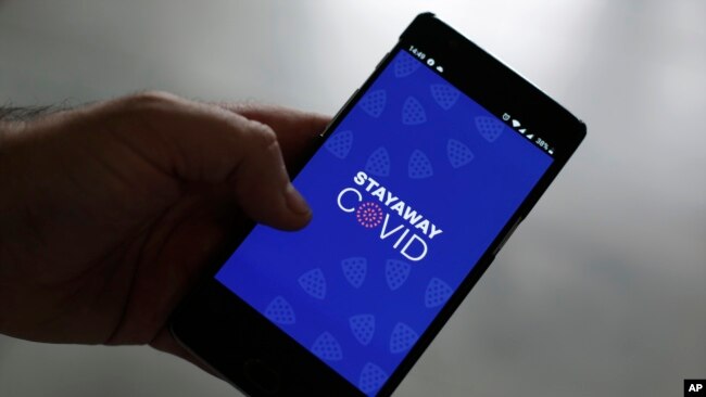 A man shows the contact tracing app Stayaway Covid on his cellphone, in Lisbon, Thursday, Sept. 17, 2020. The smartphone app uses Bluetooth technology to help discover whether people have been in close proximity to someone infected with COVID-19. (AP Photo)