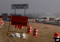 Workers leave the Ford construction site after they were sent home early the day after the U.S. auto company cancelled plans to build its plant in Villa de Reyes, Mexico.
