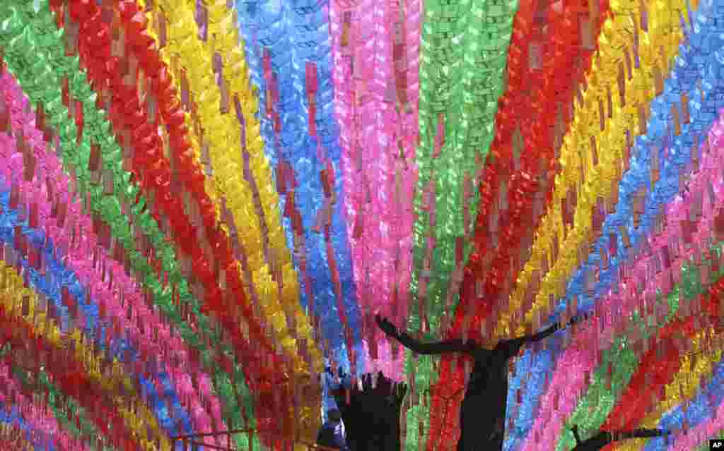 A worker checks the lanterns in preparation for the upcoming celebration of Buddha&#39;s birthday at the Jogye temple in Seoul, South Korea.