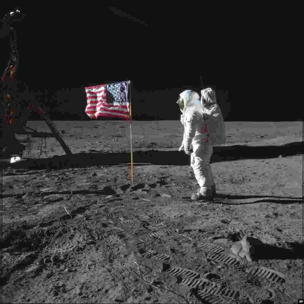 Astronot Buzz Aldrin Jr. berpose di samping bendera AS dalam misi Apollo 11. Aldrin dan Neil Armstrong adalah orang pertama yang berjalan di permukaan bulan, 20 Juli 1969. (Foto: Neil Armstrong/NASA via AP)