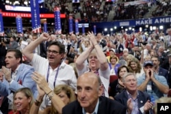 Delegates react as some call for a roll call vote on the adoption of the rules during first day of the Republican National Convention in Cleveland, July 18, 2016.