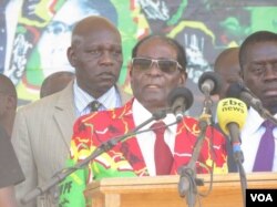 FILE - Zimbabwe President Robert Mugabe addressing members of his ZANU-PF party at a football stadium in Lupane, about 600km south west of Zimbabwe's capital (S. Mhofu/VOA)