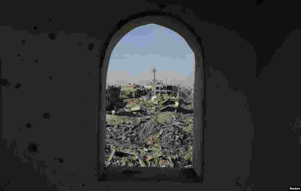 Destruction is pictured through the window of a mosque in Shejaia neighborhood, which witnesses said was heavily hit by Israeli shelling and airstrikes during an Israeli offensive, in the east of Gaza City, Aug. 1, 2014.