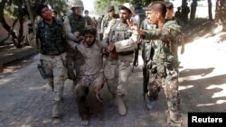 Afghan security forces escort a captured suspected Taliban insurgent during an operation in Jalalabad province in this June 19, 2013, file photo.