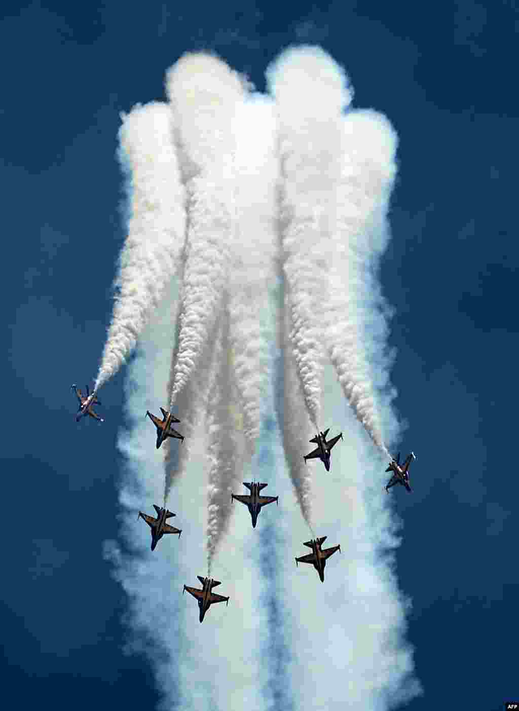 South Korea&#39;s Black Eagles aerobatics team flying KAI T-50B aircraft perform an aerial display during the Singapore Airshow at the Changi exhibition center in Singapore.