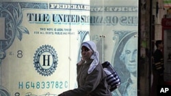 An Egyptian walks in front of a closed currency exchange in Cairo (file photo - January 31, 2011)