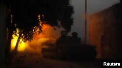 A Free Syrian Army tank fires a shell towards forces loyal to President Bashar Al-Assad in Aleppo, Nov.30, 2013.