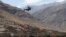 A view shows a helicopter flying over the devastated village of Adassil