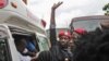 FILE - Ugandan singer-turned-politician Robert Kyagulanyi, center, better known as Bobi Wine, reacts as he gets into an ambulance after being released on bail at The High Court in Gulu, northern Uganda, Aug. 27, 2018.