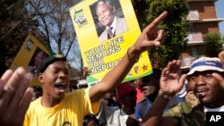 Members of the ruling party youth league sing outside the hospital where the late former South African president, Nelson Mandela, was being treated in Pretoria, South Africa, July 17, 2013. 