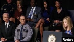 U.S. Vice President Joe Biden, bottom left, Baton Rouge Police Chief Carl Dabadie Jr., center, and U.S. Attorney General Loretta Lynch, top right, listen to Tonja Garafola, widow of East Baton Rouge Sheriff's Deputy Brad Garafola, during a memorial service for three slain Baton Rouge-area police officers at Healing Place Church in Baton Rouge, Louisiana, July 28, 2016.