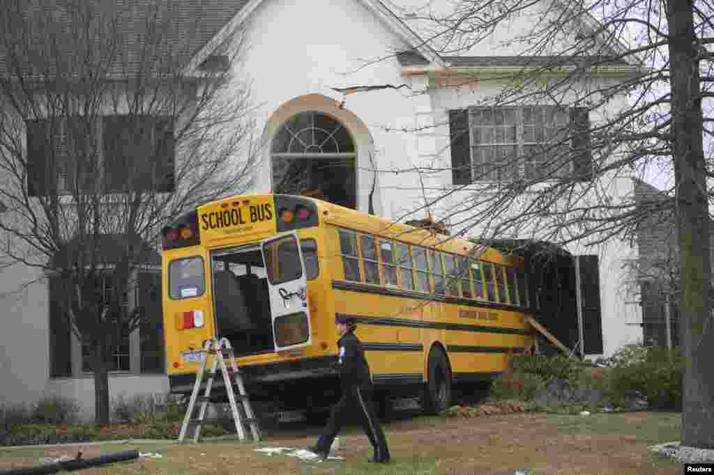 A school bus is seen after it crashed into a house at the Windermere Development in Blue Bell, Pennsylvania. The school bus carrying nine elementary school students careened off the road and crashed into a home in suburban Philadelphia home. According to police, no injuries were reported.