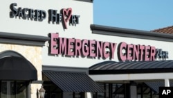 FILE - Signage for the Sacred Heart Emergency Center is seen in Houston, Texas, March 29, 2024.