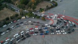 People line up in their vehicles at Dodger Stadium as post-Christmas COVID-19 testing resumes during a surge in positive coronavirus disease cases in Los Angeles, California, U.S. December 29, 2020. 