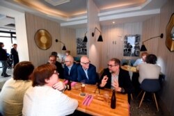 People have lunch at the restaurant Les Ambassades in Paris, on June 15, 2020, as cafes and restaurants are allowed to serve customers inside, as well as on terraces.