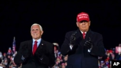 FILE PHOTO - President Donald Trump arrives for a campaign rally at Gerald R. Ford International Airport, Nov. 2, 2020, in Grand Rapids, Mich., with Vice President Mike Pence. (AP Photo/Evan Vucci)
