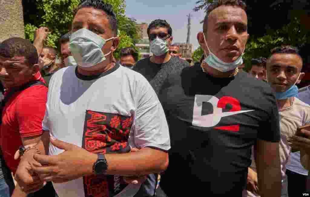 Popular Egyptian pop singers Hamo Bika, left, and Mahmoud El-Leisy, right, tour polling stations to encourage people to vote, in Cairo, Aug. 11, 2020.