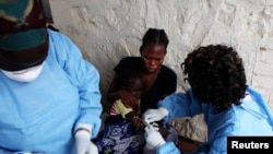 FILE - A South Sudanese girl suffering from cholera is being treated by medics in Juba Teaching Hospital in Juba, May 27, 2014. More than 1.1 million doses of oral cholera vaccine arrived in Juba, and will be dispatched next week to hot spots areas like the town of Bentiu.