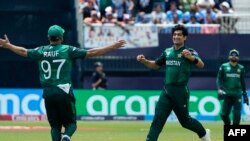 (L-R) Pakistan's Haris Rauf and teammate Naseem Shah celebrate after Shah took his third wicket during the ICC men's Twenty20 World Cup 2024 group A cricket match between India and Pakistan at Nassau County International Cricket Stadium in East Meadow, Ne